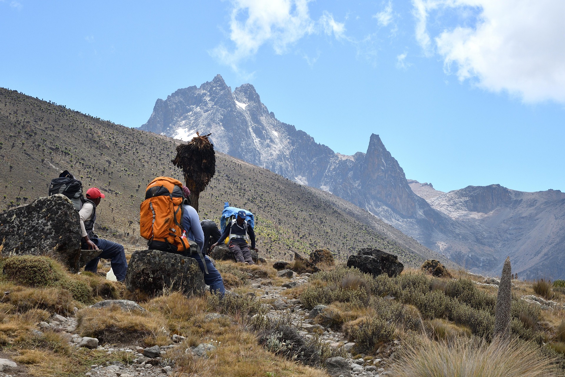 Porters and trekkers sitting and having a rest on Mount Kenya trek