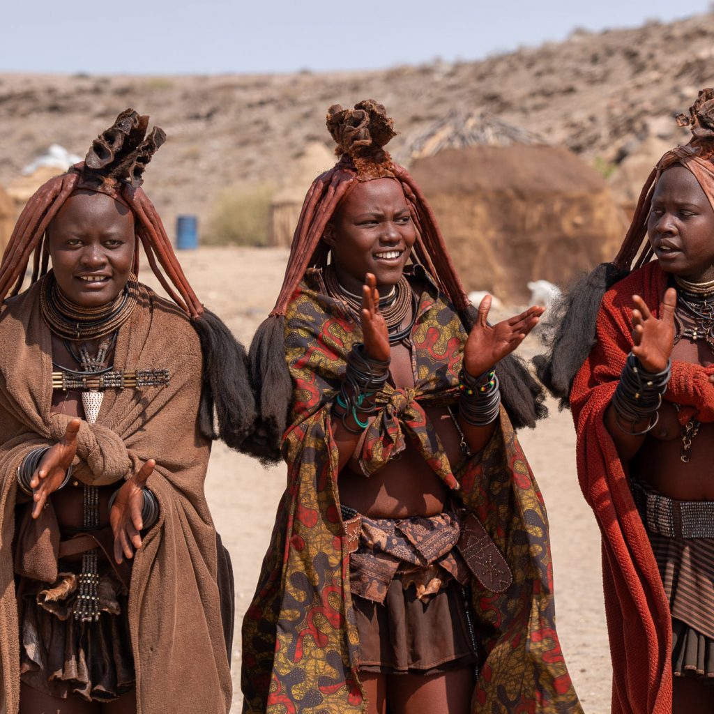 Three Himba ladies in traditional village