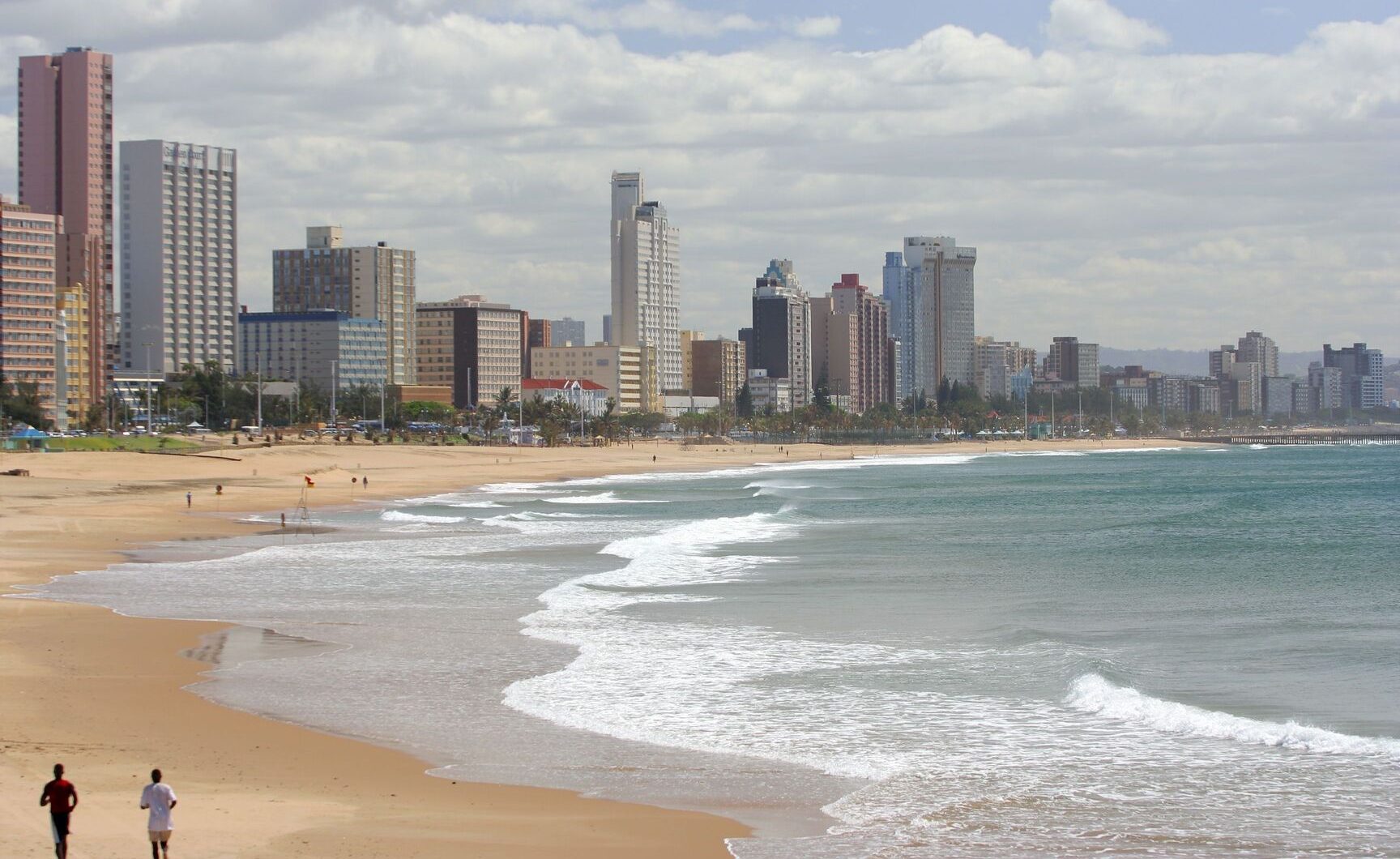 Golden Mile, Durban, walkers on beach sand in foreground