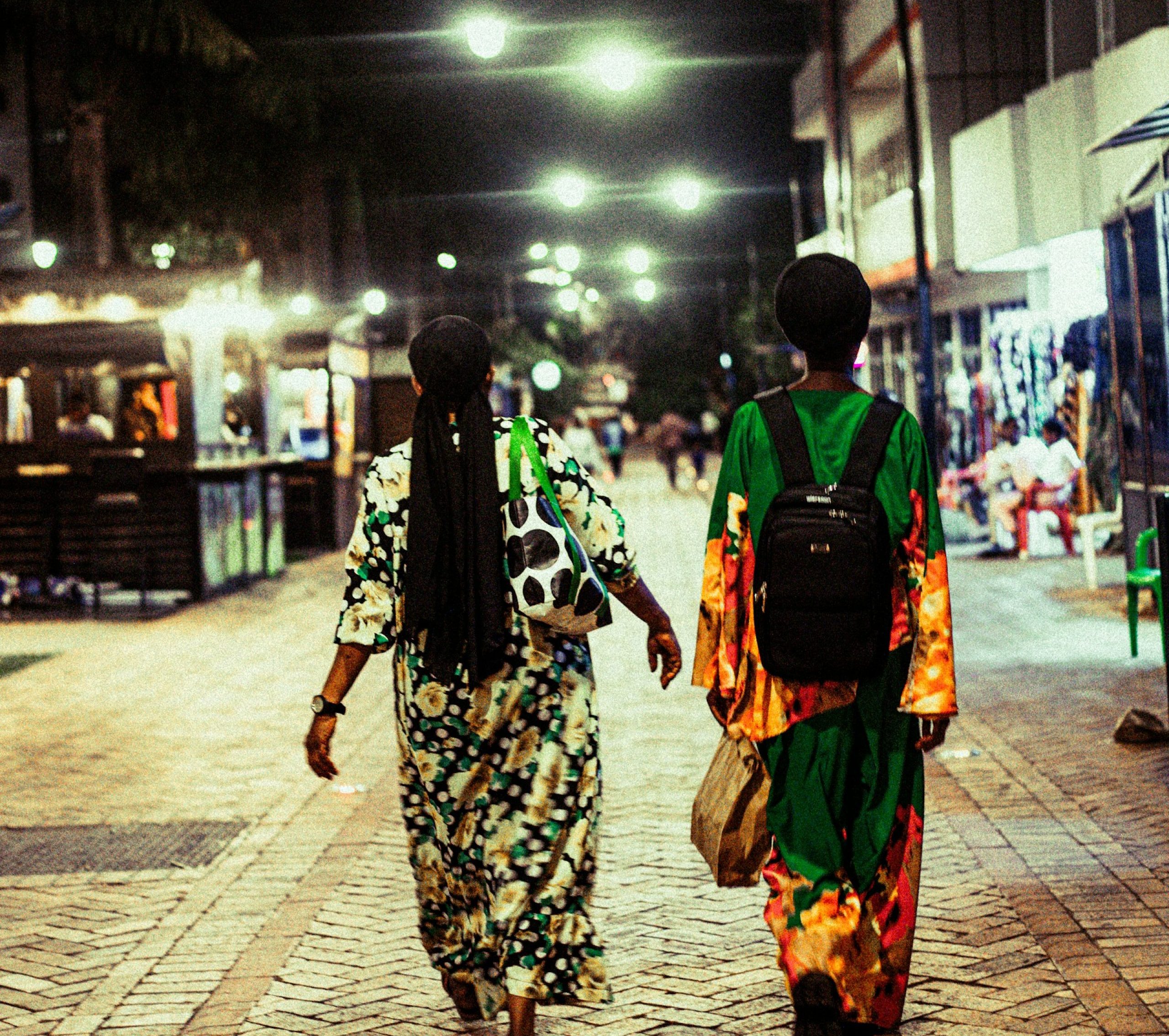 Two women walking down Kigali street at night. Countries that are safe for women