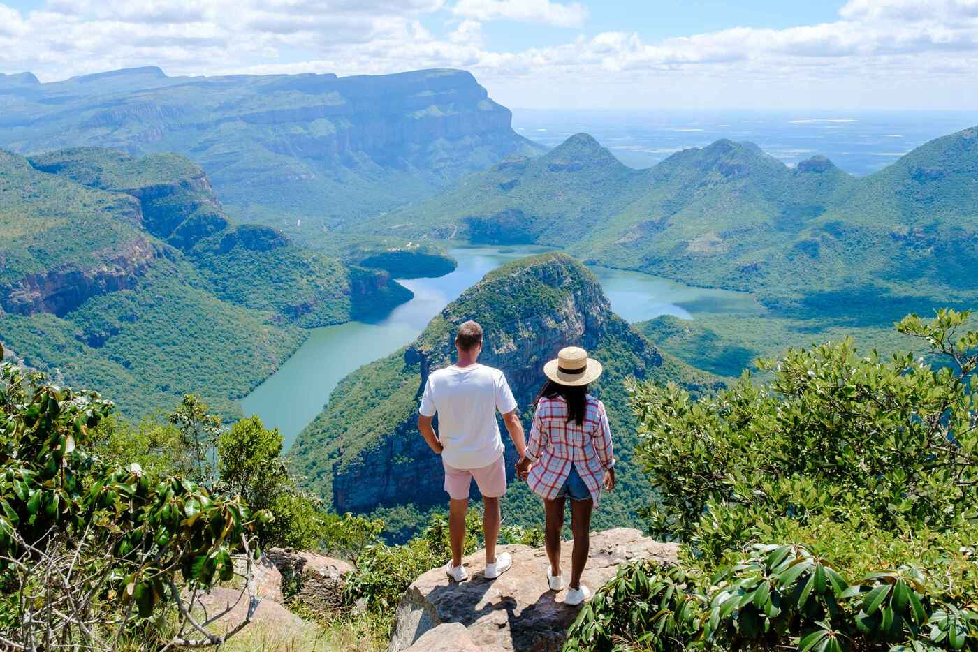 Man and woman holding hands while looking out over Blyde River Canyon, Mpumalanga, Panoramic Route, South Africa(1)
