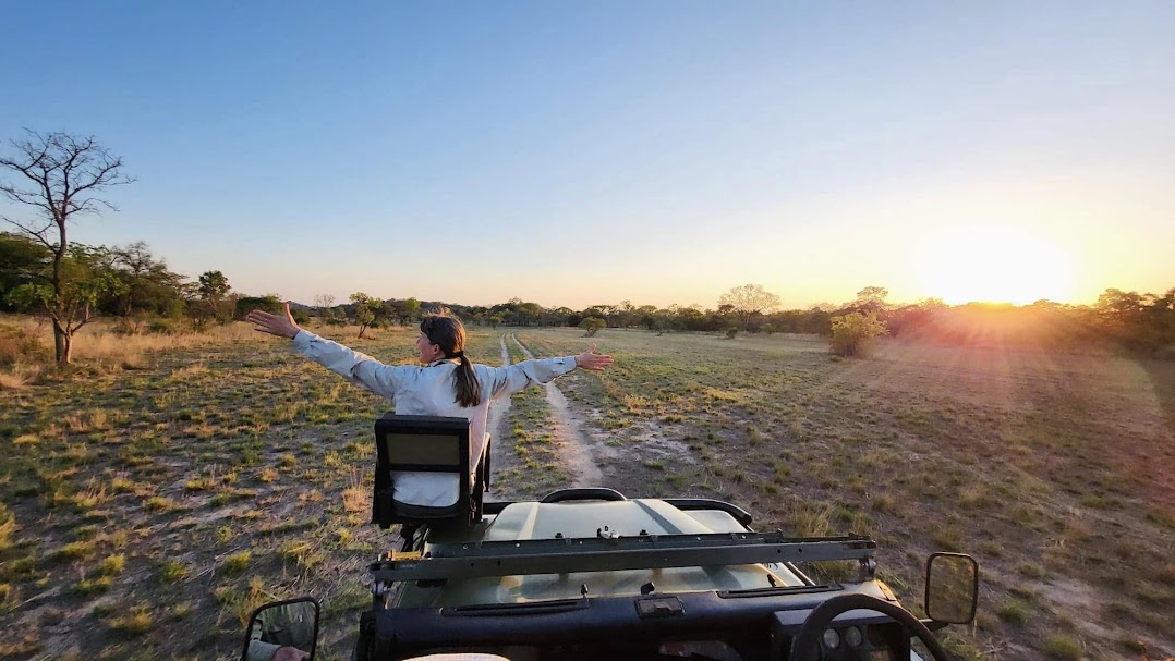 happy traveler on safari vehicle