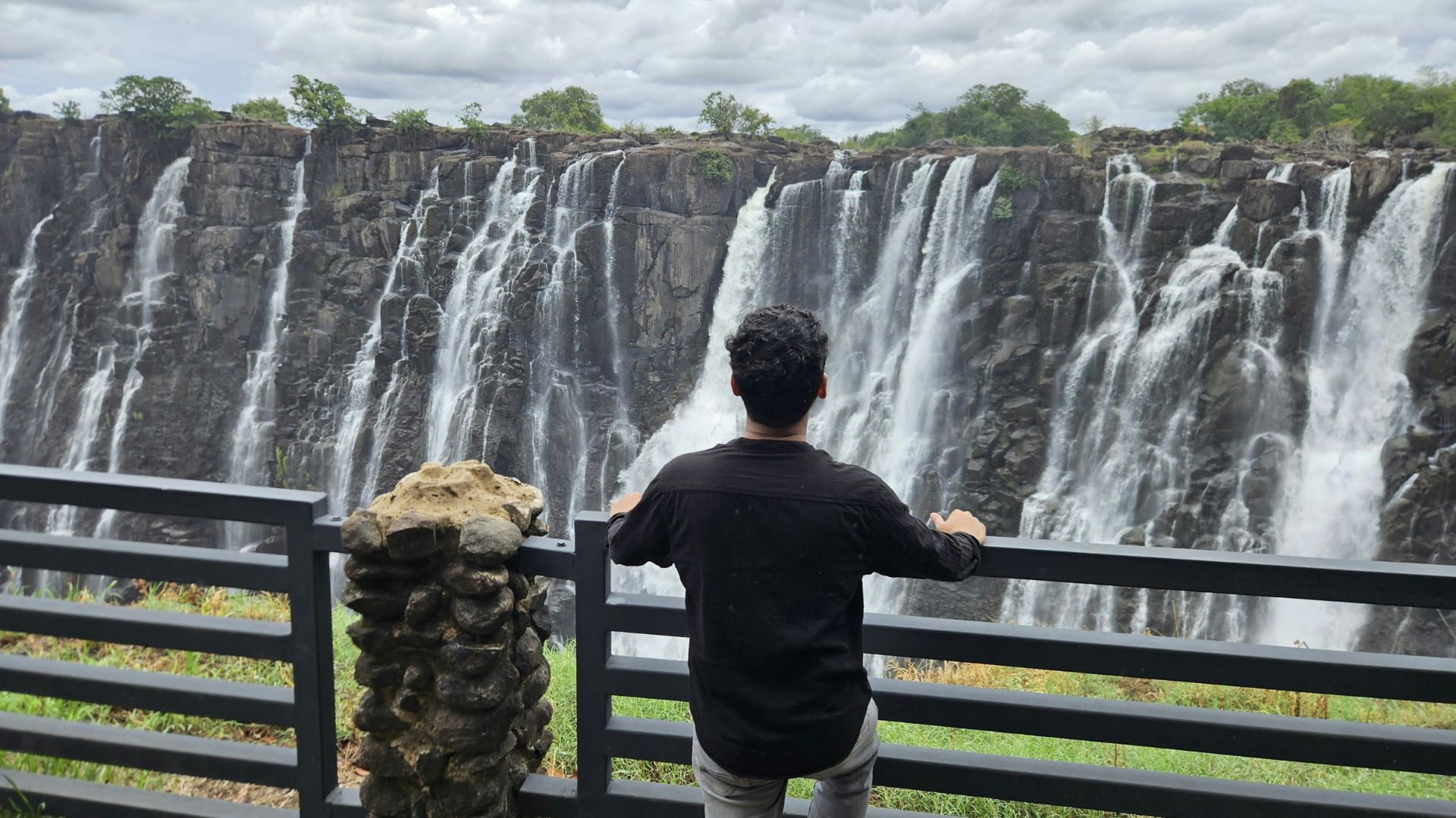 Man at viewing point of Victoria Falls, Zimbabwean side