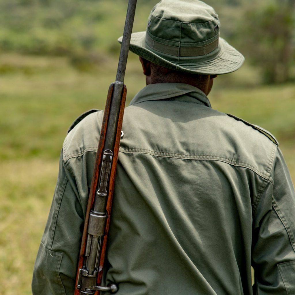 African park ranger with rifle seen from behind(1)