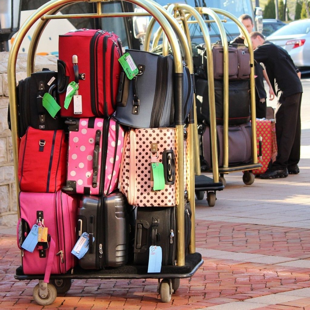 Luggage on trolley on street outside a smart hotel(1)
