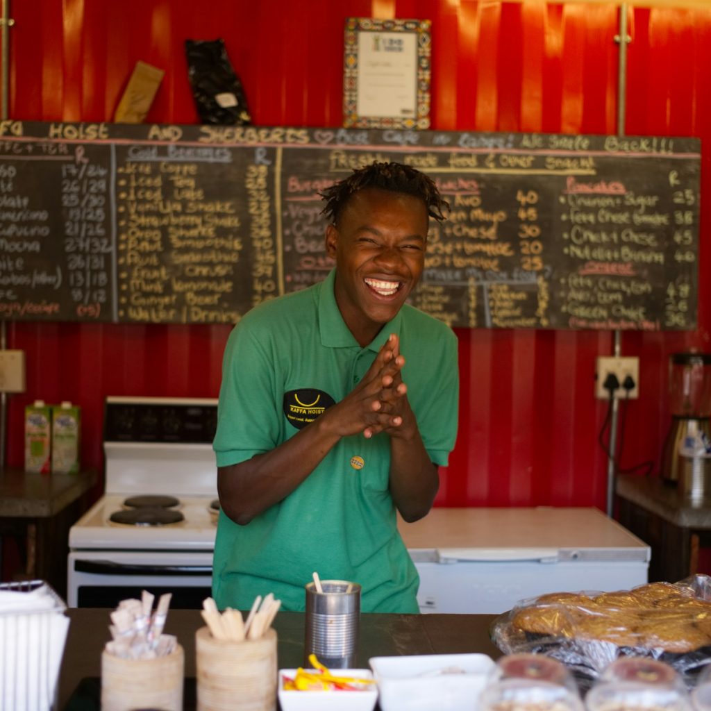 Smiling barista or server at a takeaway eatery in Cape Town
