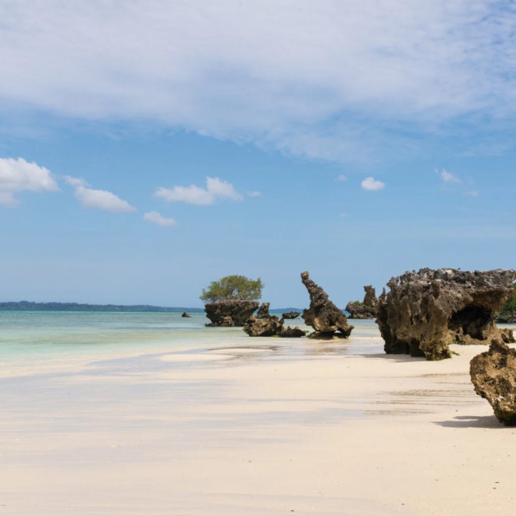 White sands and turquoise waters and broken off pieces of coral reef, serene and secluded Pemba Beach, Explore Mozambique