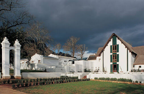 Historic Cape Dutch architecture at the entrance of Rustenberg Wine Farm's original wine cellar in Stellenbosch, South Africa