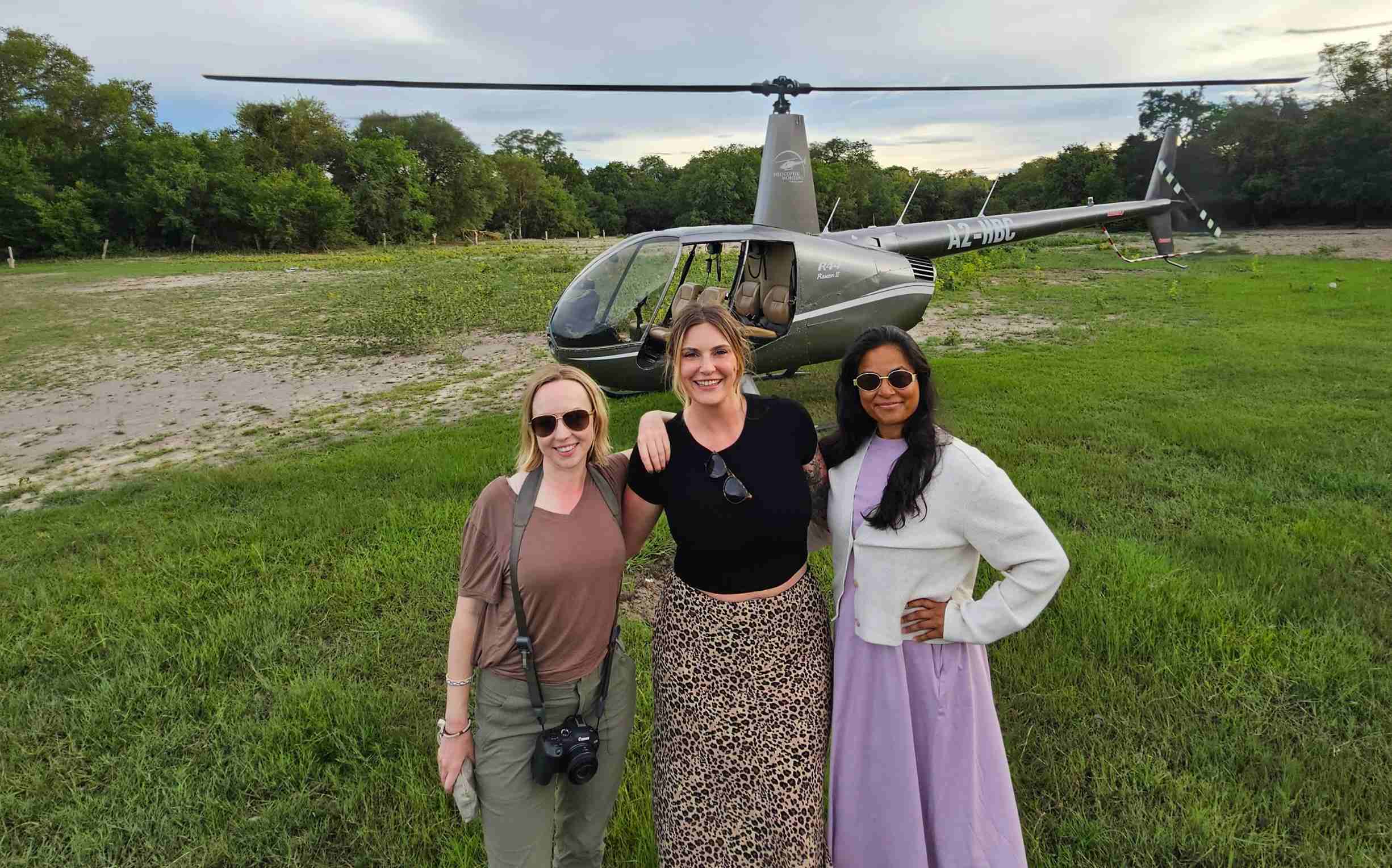 three female travellers in botswana africa going on a helicopter flight over the delta