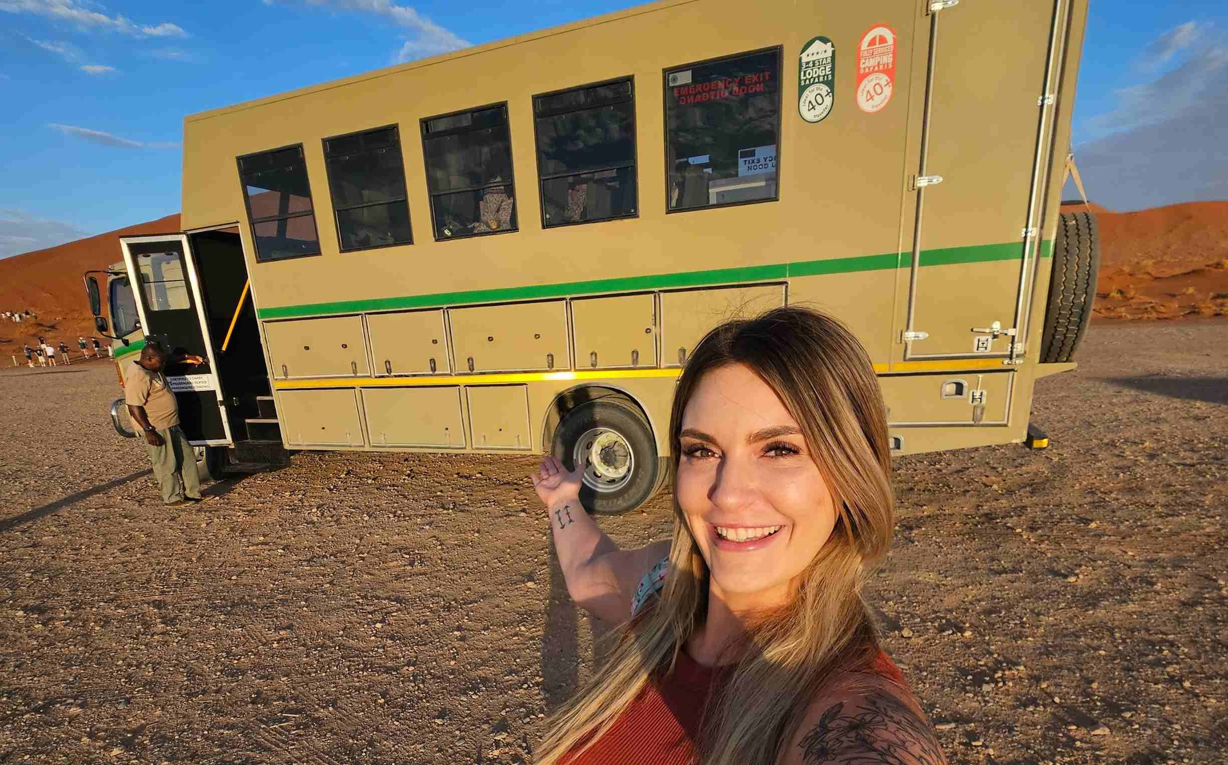 woman standing in front of overland truck