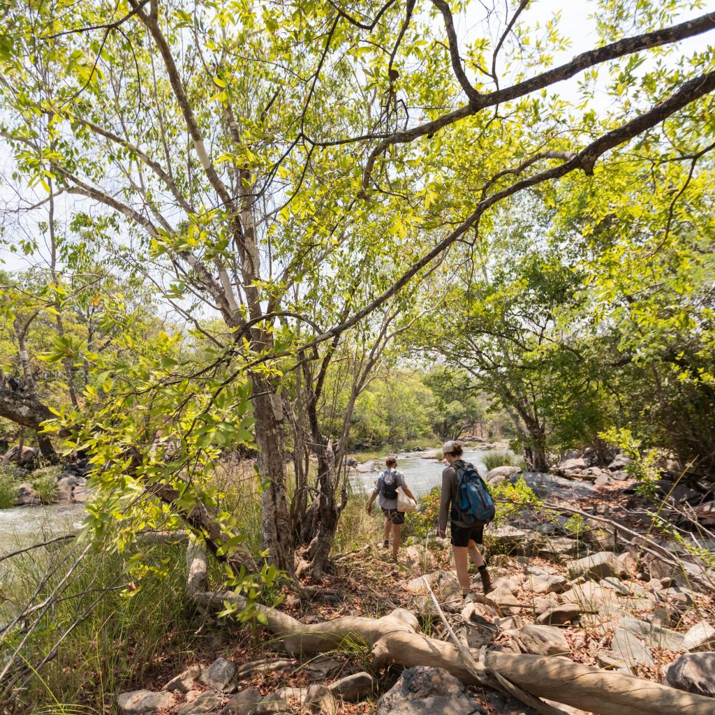 Couple of hikers walk to Lufila Falls in North Lungwa National Park, Zambia, part of the Amatololo Experience
