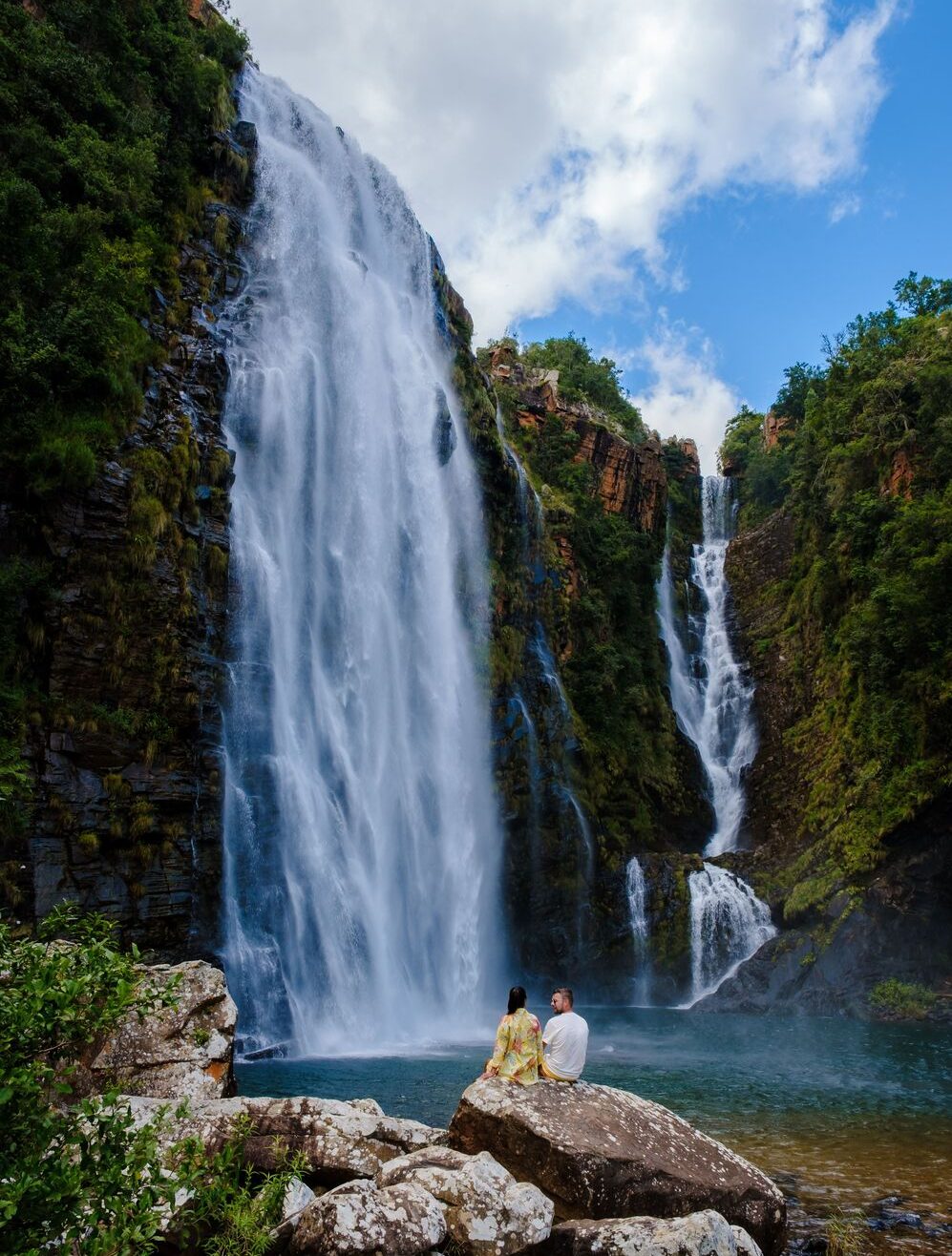 Lisbon Falls with couple seated on rocks by pool