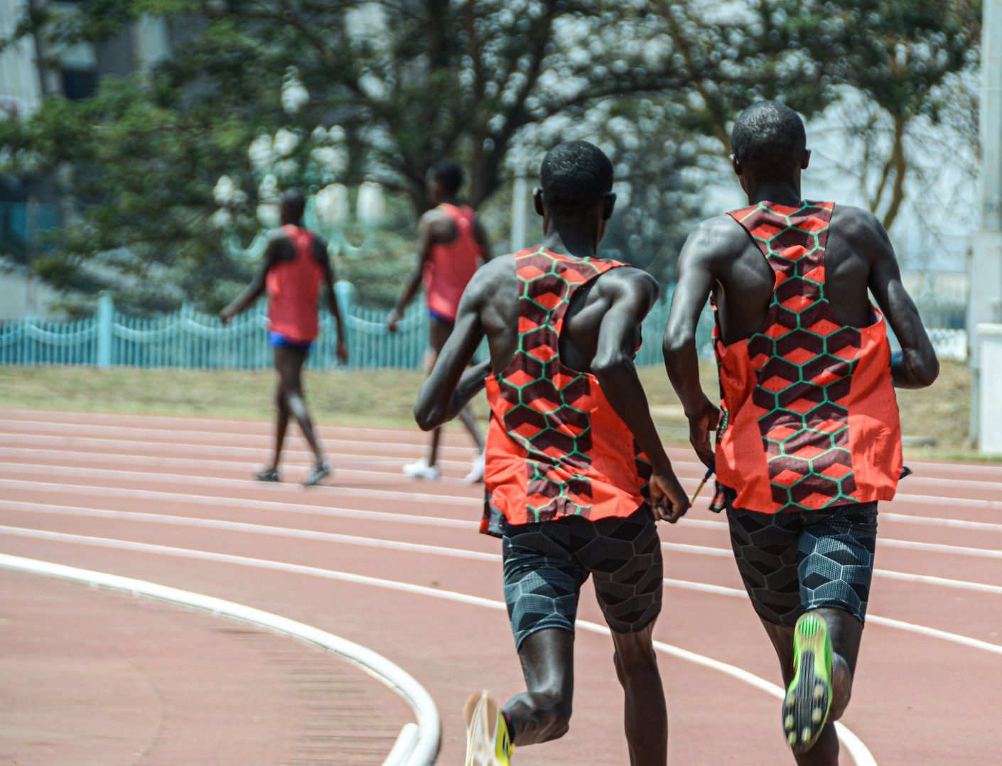 two Kenyan men running on track