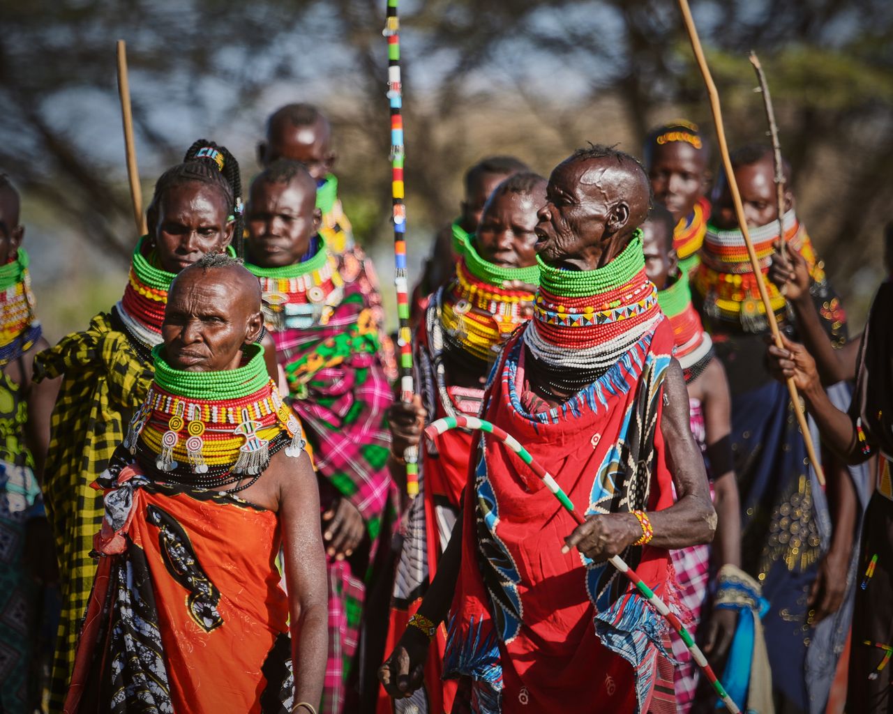 a group of people in traditional maasai attire showcasing vibrant beadwork