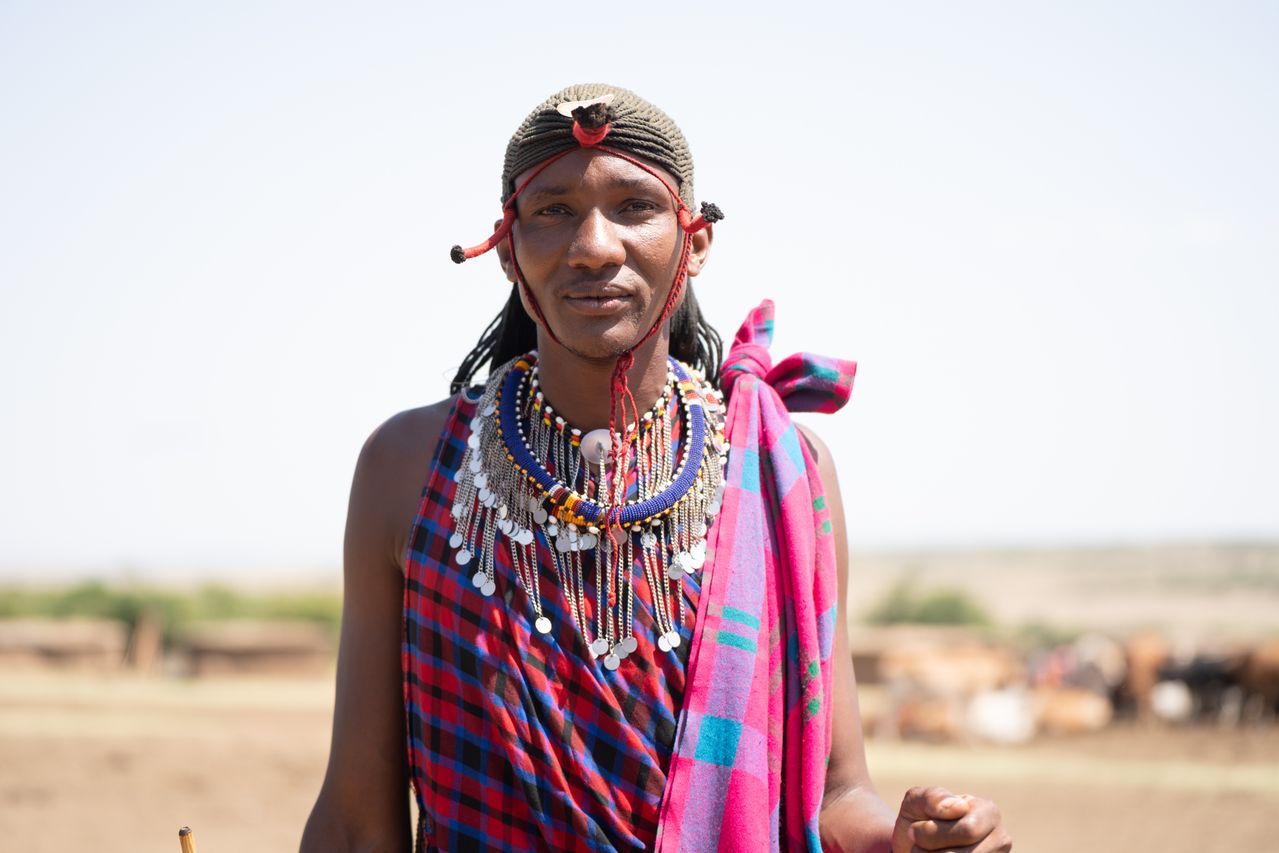 portrait of maasai tribe member in traditional attire showcasing vibrant colours and cultural heritage in kenya