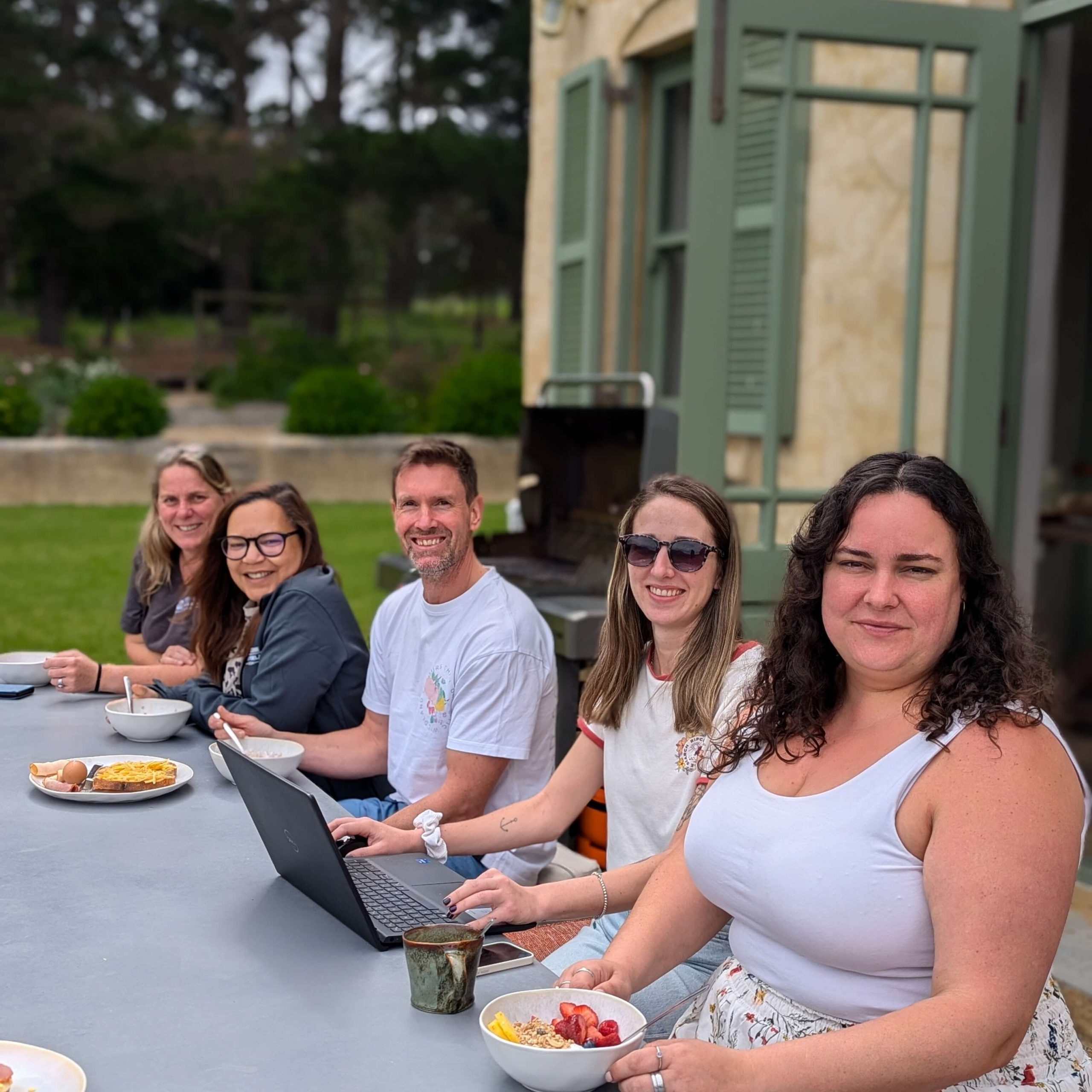 africa overland tours team members working and having breakfast together
